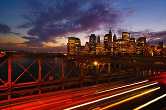USA, New York State, New York City, Lower Manhattan and Brooklyn Bridge at dusk.