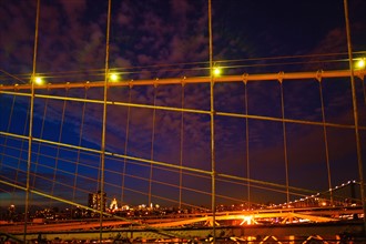 USA, New York State, New York City, Midtown Manhattan and Brooklyn Bridge at night.
