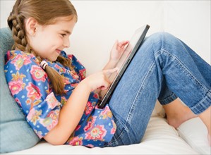 Girl ( 6-7) using digital tablet. Photo : Jamie Grill