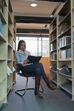 Female student studying in library. Photo : Jan Scherders