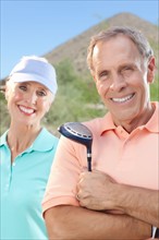 Portrait of couple on golf course. Photo : db2stock