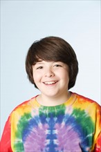 Studio portrait of boy (10-11) in colorful shirt. Photo : Rob Lewine
