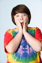Studio portrait of boy (10-11) in colorful shirt. Photo: Rob Lewine