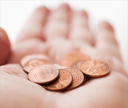 Hand with one cents coins.