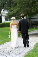 Newly wed couple walking together.