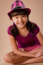 Studio portrait of girl (10-11) wearing hat. Photo : Rob Lewine