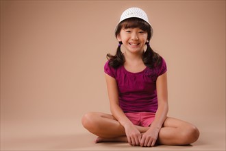 Studio portrait of girl (10-11) wearing hat. Photo : Rob Lewine