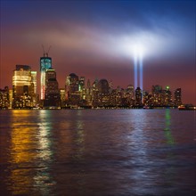 USA, New York, New York City, Cityscape at night with tribute in light.