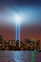 USA, New York, New York City, Cityscape at night with tribute in light.