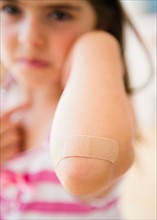 Girl ( 6-7) showing elbow with adhesive bandage. Photo: Jamie Grill