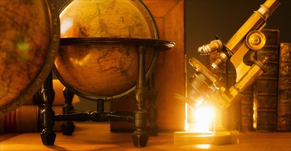 Studio shot of antique globes and microscope.