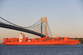 USA, New York State, New York City, Brooklyn, Container Ship under Verrazano-Narrows Bridge. Photo
