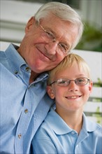 Portrait of grandfather and grandson (10-11).
