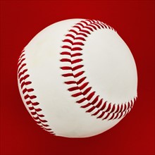 Baseball on red background.