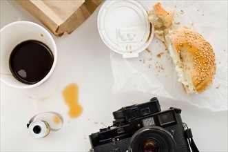 Breakfast and camera on table, studio shot.