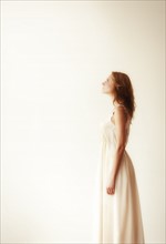 Woman against white background, studio shot.