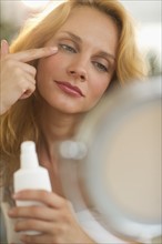 Woman applying make-up.
