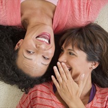 Women lying down and laughing.
