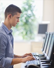 Teenage student (16-17) in computer lab.
