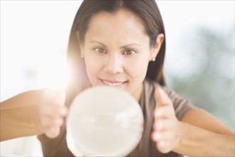 Woman looking into crystal ball.
