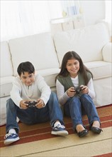 Brother (12-13) and sister (10-11) playing video games.