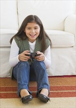 Girl (10-11) playing video games.