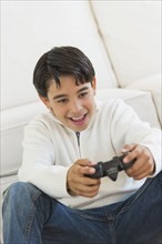 Girl (12-13) playing video games.