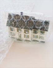 Studio shot of house wrapped in bubble wrap.