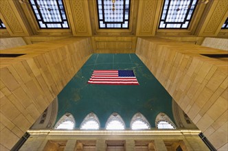 USA, New York State, New York City, Interior of Grand Central Station with American flag.