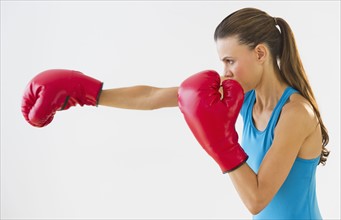 Studio shot of woman boxing.