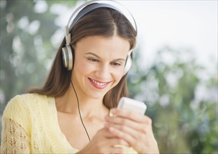 Woman with headphones outdoors.