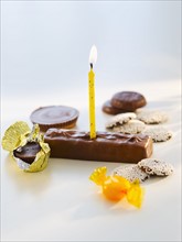 Studio shot of chocolate bars with birthday candle.