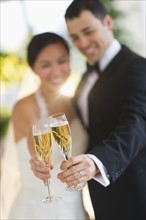 Bride and groom toasting with champagne.