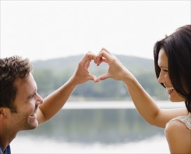 Roaring Brook Lake, Couple making heart shape with hands. Photo: Jamie Grill