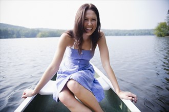 USA, New York, Putnam Valley, Roaring Brook Lake, Woman sitting in boat. Photo : Jamie Grill