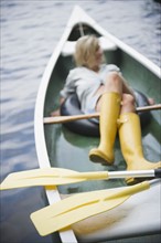 Roaring Brook Lake, Woman sitting in boat. Photo: Jamie Grill