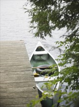 Roaring Brook Lake, Boat moored at pier on lake. Photo : Jamie Grill
