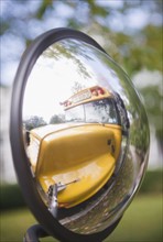 Reflection of school bus in rear view mirror. Photo : Jamie Grill