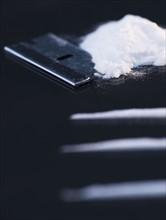 Close up of cocaine and razor on black background. Photo : Daniel Grill