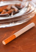 Close up of cigarette and glass ashtray. Photo: Daniel Grill