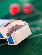 Close up of open cigarette pack on casino table. Photo : Daniel Grill