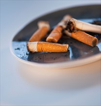 Close up of cigarette butts in ashtray. Photo: Daniel Grill