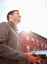 Man visiting city with city map. Photo: Daniel Grill