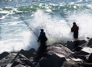 USA, New York, Long Island, Montaurk, Men fishing in sea. Photo: fotog