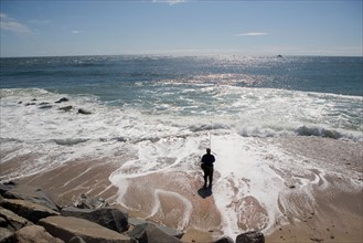 USA, New York, Long Island, Montaurk, Man fishing in sea. Photo: fotog