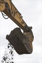 Low angle view of digger scoop full of soil. Photo : fotog