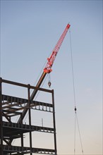 Crane with unfinished built structure. Photo : fotog