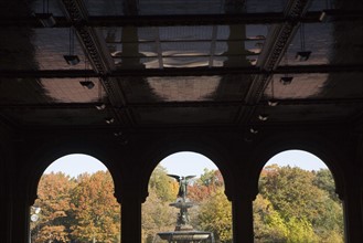 USA, New York City, Central Park, Bethesda Fountain with angel statue as seen through ach colonnade