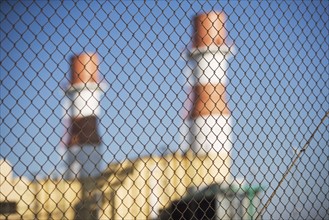 USA, New York City, Industrial plant behind wire mesh fence. Photo: fotog