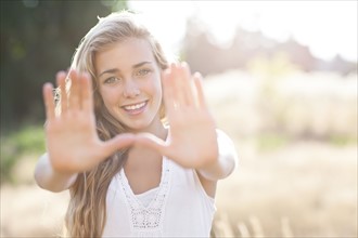 Teenage girl (16-17) displaying stop gesture. Photo: Take A Pix Media